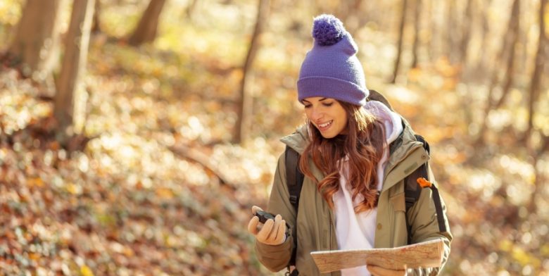 a woman hiking surrounded by fall foliage on a getaway in Maryland