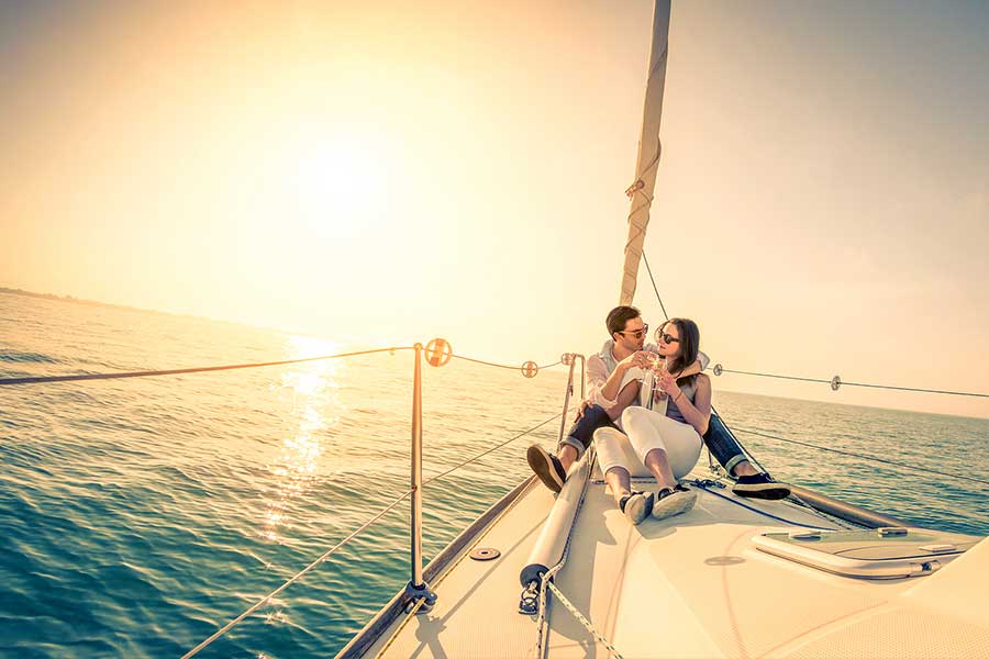 Couple sailing and drinking champagne on a boat