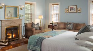 King bed and fireplace in the Sunrise in the Garden Cottage at Brampton Inn