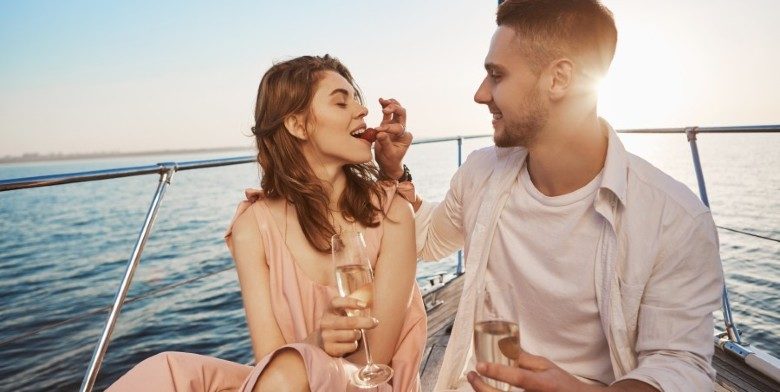 Couple eating strawberries while sailing in Maryland