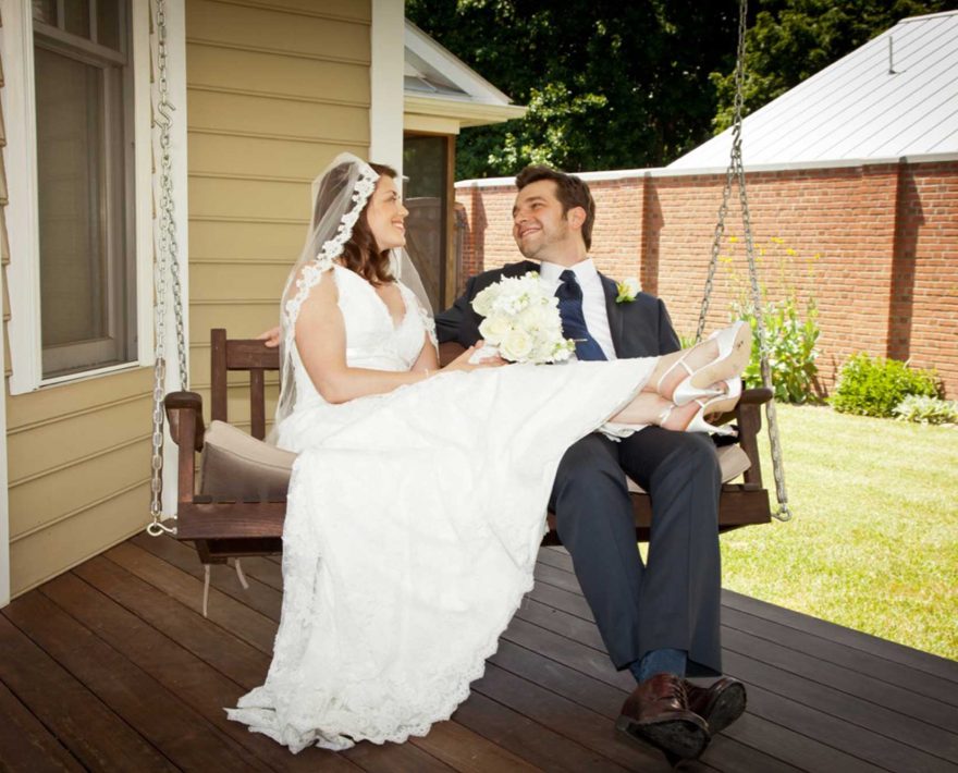 Bride and groom on a porch swing