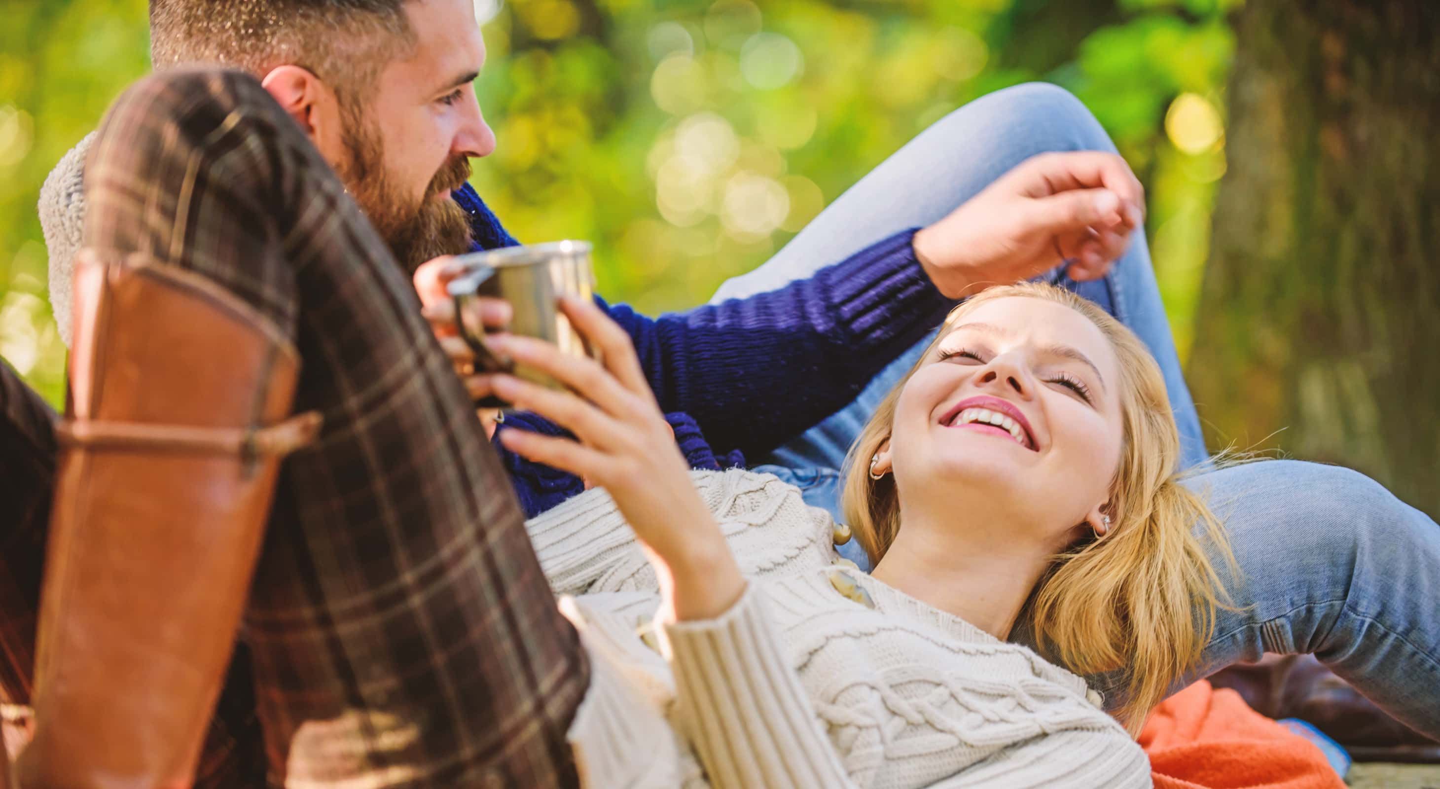 Couple relaxing in the woods enjoying a romantic getaway