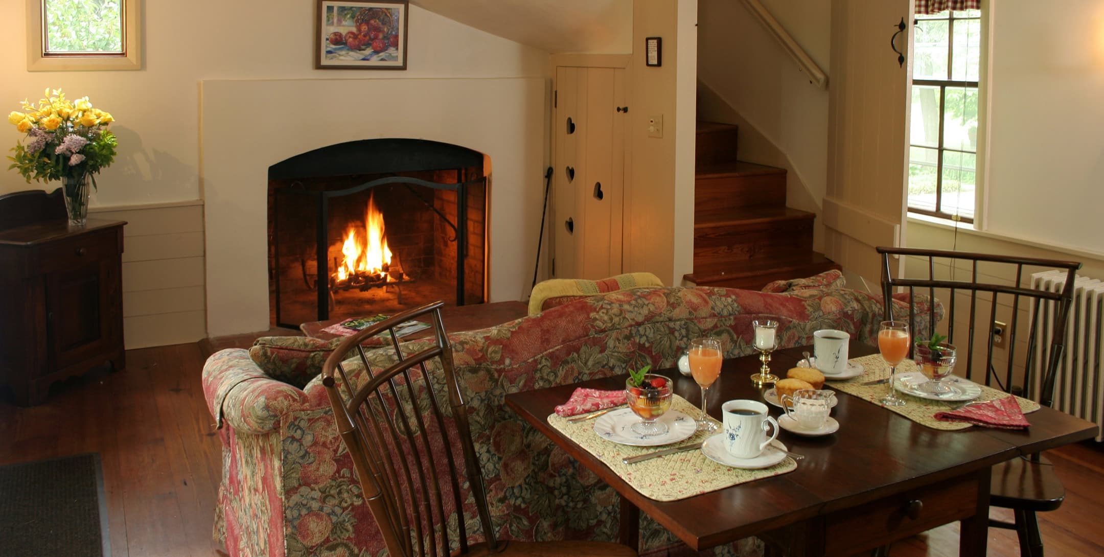 dining table and living room with fireplace in the Fairy Hill Suite