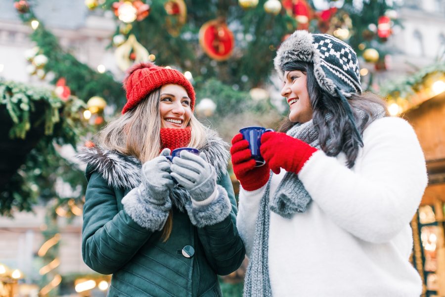 two friends drinking hot chocolate at a Maryland Christmas event