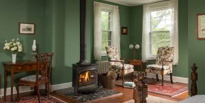 Wood stove and sitting area in the Green Room at Brampton Inn