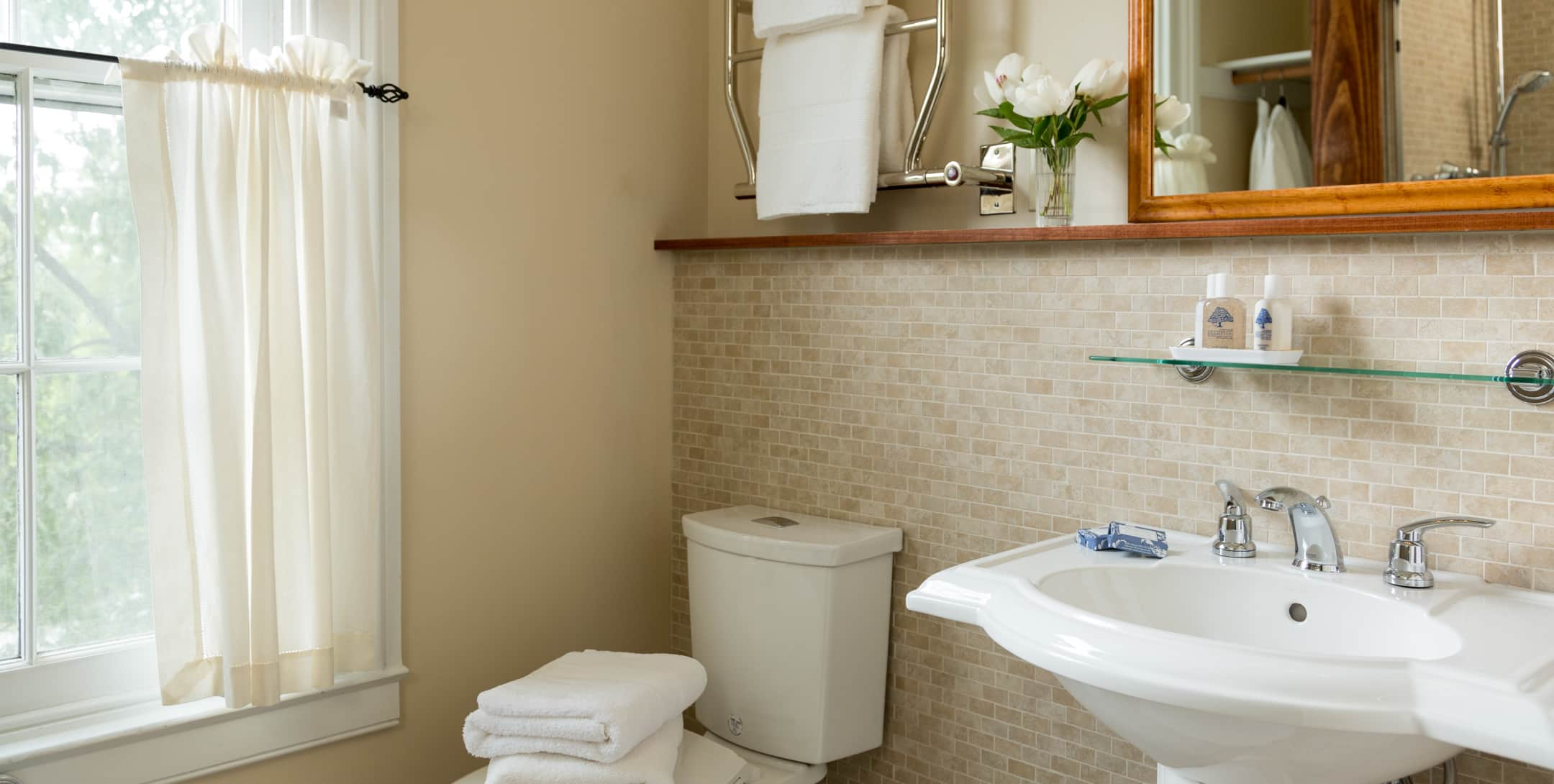 Bathroom in the Red Room with a tub/shower combo and a window overlooking a garden