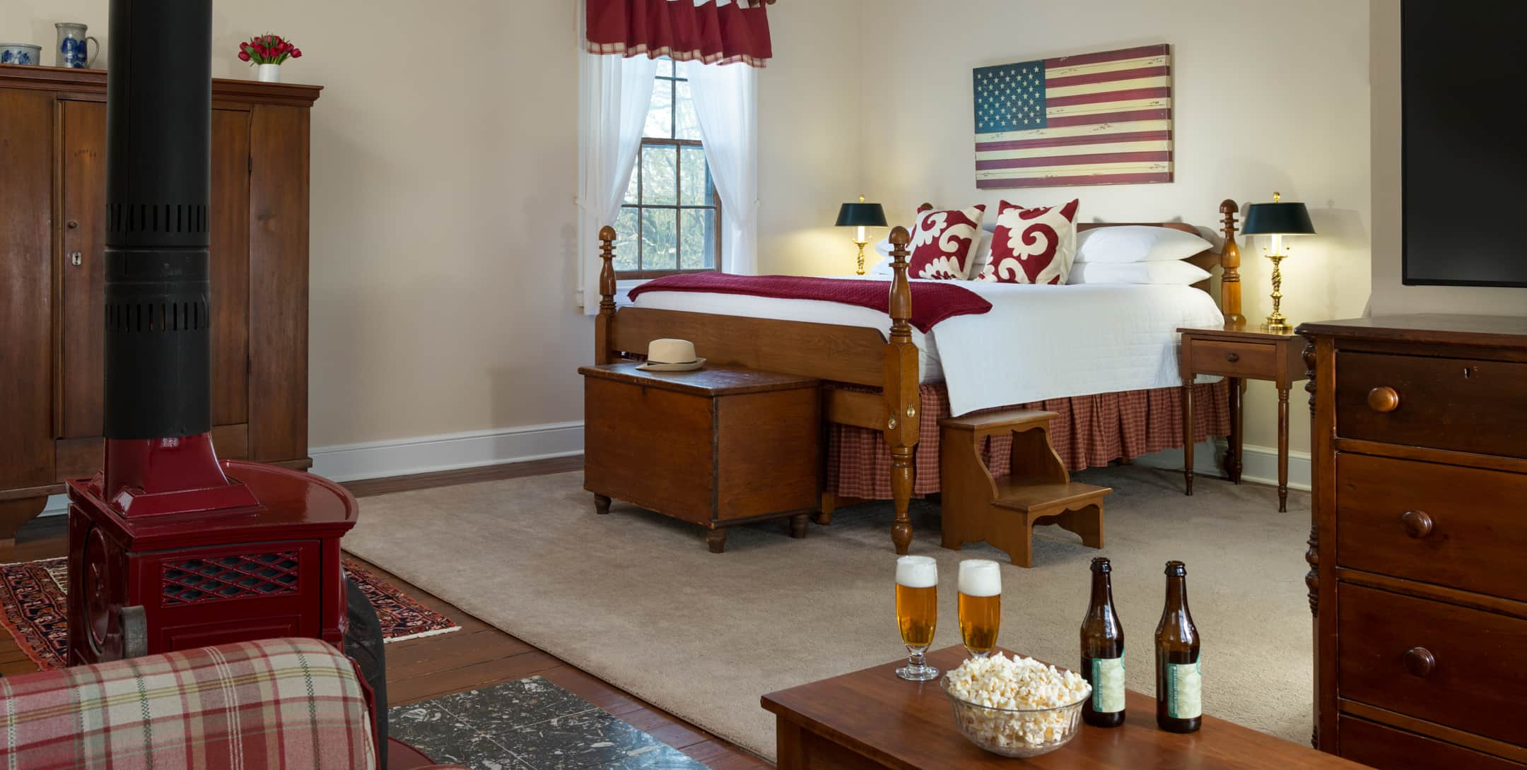 King bed in the Red Room at Brampton Inn with an American Flag wall art