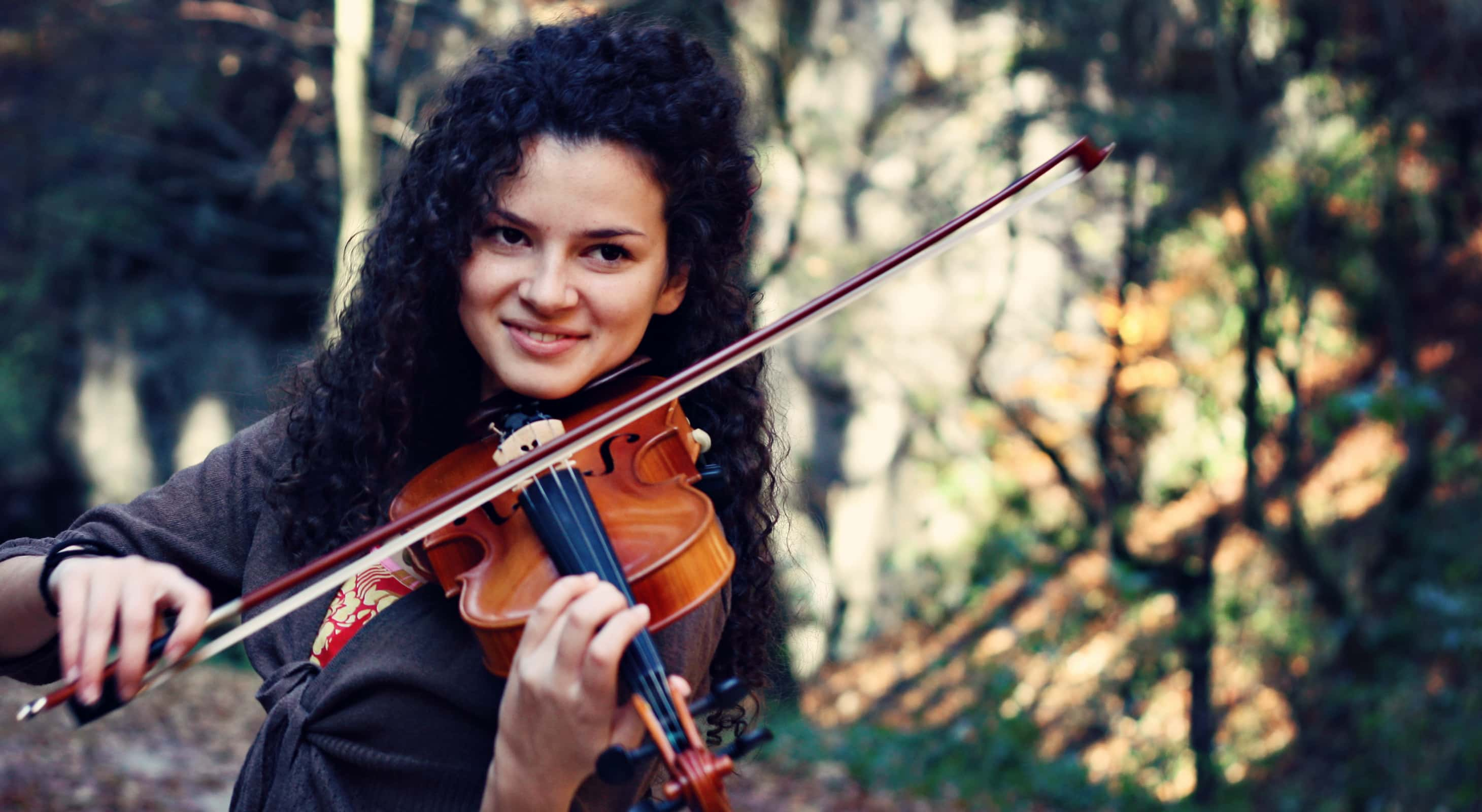 Woman playing violin at outdoor event