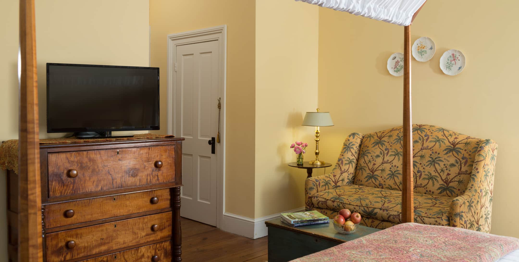Flatscreen TV on a dresser in the Yellow Room at Brampton Inn